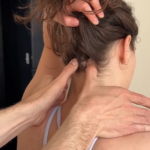 A Person Receiving a Neck Massage with A Focus on Pressure Points at The Base of The Skull, Using Targeted Finger Pressure for Relief