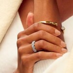 Close-Up of A Woman's Hand Wearing a Diamond Engagement Ring and Gold Bracelet