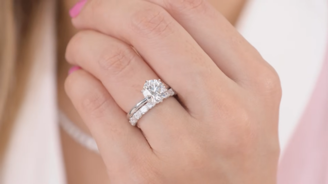 Close-Up of A Hand Wearing a Solitaire Engagement Ring